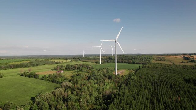 Clean looking windmills in lush green countryside, green energy.