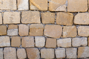 Background texture of warm coloured stone blocks in a wall