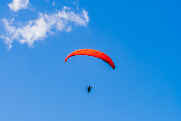 View of the sky. Person flying in a paraglider, leisure activity. Travel and landscapes.
