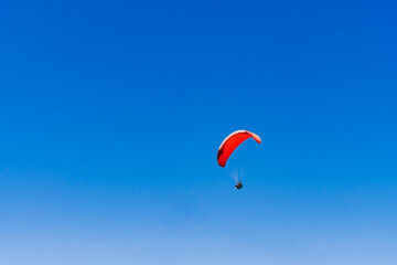 View of the sky. Person flying in a paraglider, leisure activity. Travel and landscapes.