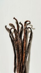 Dried vanilla beans against a pristine white background