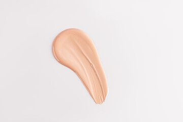 The texture of the foundation cream, a stroke on a white background. top view. A copy space. A sample of foundation. layout. template.