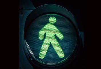 traffic light with a green man on a black background
