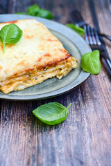  Italian Lasagna bolognese  covered with parmesan cheese  on awooden  background.