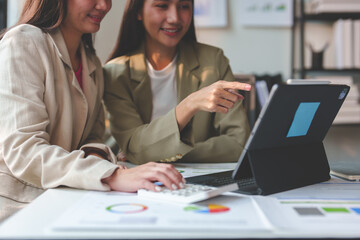 Business idea creative brainstorming sessions for projects Strategic topic of two Asian girls working together data analysis Happy clarification of various financial information at the desk.