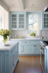 Fototapeta premium Modern kitchen with light blue cabinets, wood floors, and white countertop.