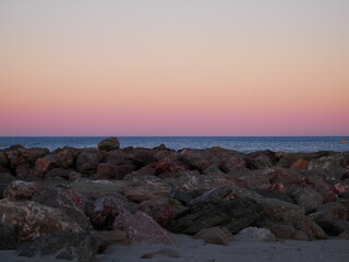 View on rocks with the sea in the background during a sunset