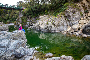 hiker girl enjoys the unique scenery of pelorus bridge scenic reserve in marlborough region of new zealand south island; famous pelorus bridge