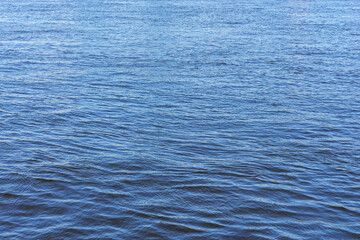 The texture of ripples on the water. Natural background.