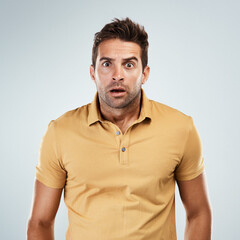 Fototapeta premium Portrait, man and surprise with worry in studio for fake news, announcement and horror of gossip information. Shocked, male person and facial expression for wow, drama secret and white background