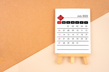 2025 July calendar page on brown background.
