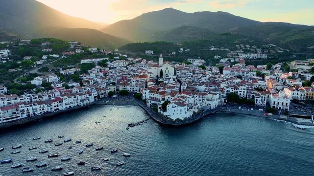 Drone shot of mediterranean Spanish coastal town of Cadaques. Small tourist village on the Costa Brava. Aerial view of the beach and the bay in Spain at sunset