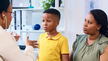 Doctor Consulting with Concerned Child and Parent in a Medical Office Setting