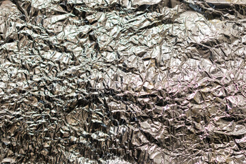Crumpled white foil. Abstract glowing textured background. Holidays. New Year. Festive background
