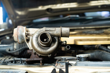 Old air filter on the hood of a car. Close-up.The old car air filter has expired and must be...