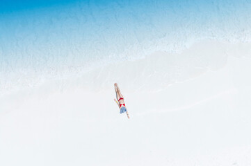 Fresh of summer with young woman relaxation  as lying on the beach  in Maldives