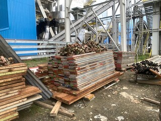 Lot of Asiba scaffolding and double clamp lay on the site power plant area .The photo is suitable to use for industry background photography, power plant poster and maintenance content media.