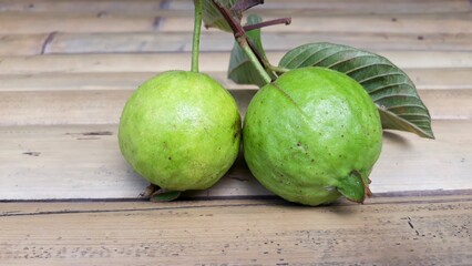Fresh green guava on wooden bamboo table 
