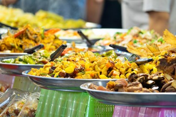 A table full of Thai food with a variety of dishes including meat, Thai food ,Thai Market street food
