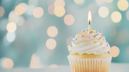 Cupcake with a single lit candle and colorful sprinkles on a pastel bokeh background, perfect for birthday celebrations.