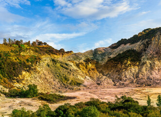 landscape of Plegrean volcano fields in Naples Italy near Pompeii with sulfur yellow caldera duribg eruption of smoke. campi Flegrei and cataclysm of Earthquake