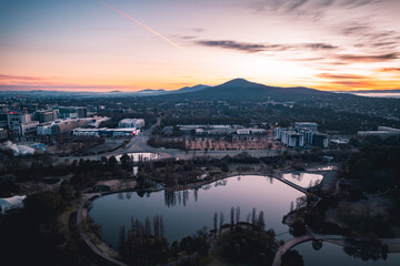 High angle view of river by buildings against sky during sunset