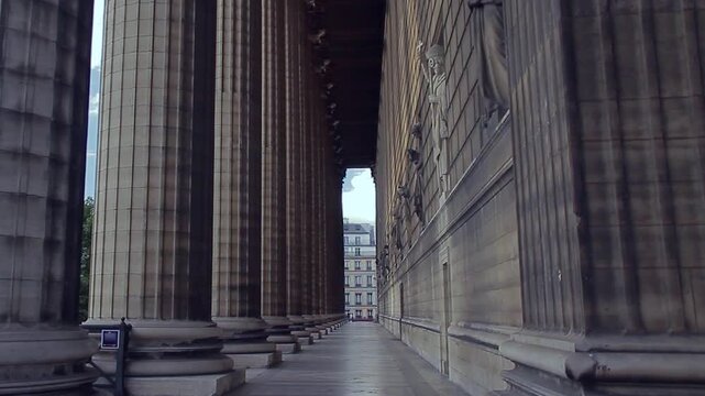 Side facade of the Madeleine Church in Paris, surrounded by Doric columns. Paris