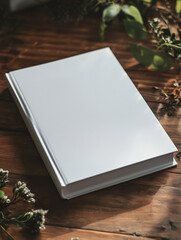  white soft cover book lying on the table, birds eye view