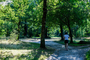 Man listening to music while jogging on cycle paths in southwest France