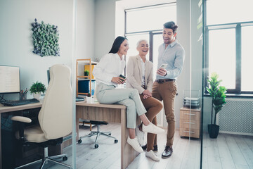 Photo of business people relax laughing reading jokes social network gadget in office