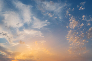 A dramatic sunset with a colorful sky, featuring vibrant hues of orange, red, and yellow as evening descends.
