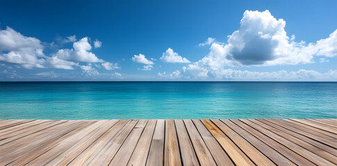 Fototapeta premium Wooden deck in front of clear blue ocean with clouds in the sky