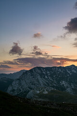 Epic Sunset over Incredible Driving Road - sunburst on Durmitor National Park Mountains. Sedlo Pass and Bobotov Kuk Adventure, Montenegro - the foot of the Balkan Alps