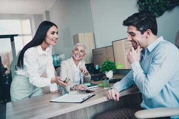 Photo of three business people in modern office discuss start up project