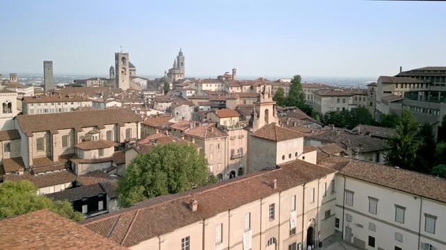 Aerial shot of upper Bergamo approaching the monumental centre: Piazza mercato delle Scarpe, Piazza Cittadella, Campanone, Torre del Gombito, Duomo, Colleoni Chapel, Sarpi classical high school.