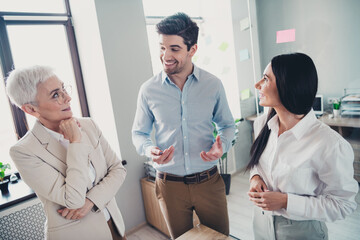 Photo of two employees mature boss woman talk discuss office team meeting professional collaborating working together in modern workplace