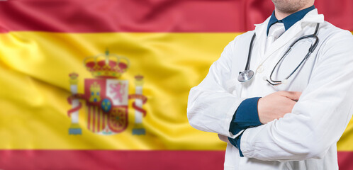 Male doctor with stethoscope on Spanish flag isolated. Spanish Health and Care concept. Doctor with...