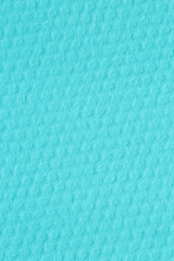 close up of  textured watercolor paper stained in turquoise color