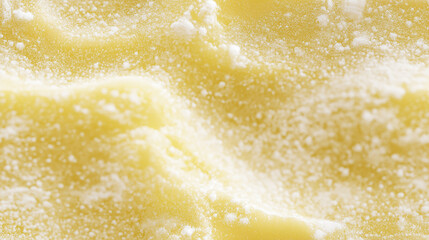 Extreme close-up of a single ladyfinger surface texture. Pale yellow, spongy texture with a light dusting of powdered sugar.