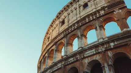 Fototapeta premium A stunning view of the Colosseum in Rome reveals its ancient architecture. The structure stands tall against the clear blue sky. This image captures the beauty and history of Italy. AI