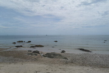 On the beach on a hot, sunny day with open skies.