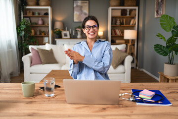 Business woman video call. Young successful female working at home office talking on laptop webcam with colleagues, having virtual staff meeting, giving advice or online training with new employees.