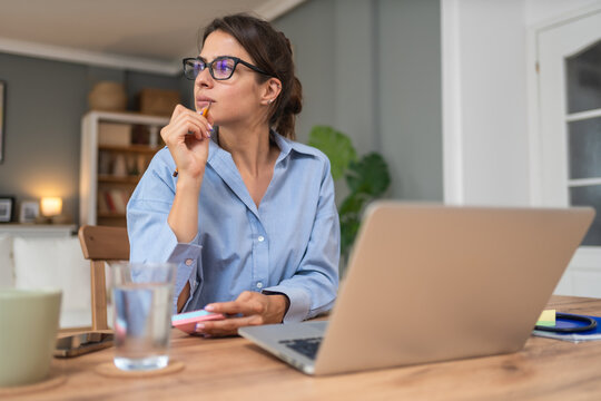 Business woman video call preparation. Young female businessperson prepare herself for online meeting, making notes for internet presentation, thinking and planning for better achievement with client.