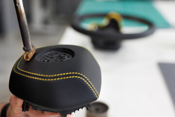 Master applies an engraving, an inscription on the steering wheel during tightening and restoration.