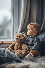 A young child sits comfortably by a window, holding a teddy bear. The scene exudes warmth and comfort, with a soft focus on the background and cozy surroundings.