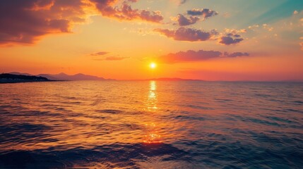 Obraz premium A mesmerizing sunset over the vast ocean, with the sky painted in vibrant hues of orange, pink, and purple, reflecting brilliantly on the calm waters below.
