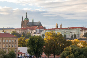 Overview of old Prague at sunset time in October, autumn Prague with yellow trees and red roofs