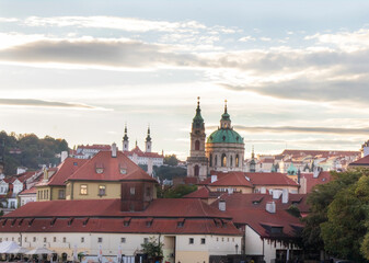 Fototapeta premium Overview of old Prague at sunset time in October, autumn Prague with yellow trees and red roofs