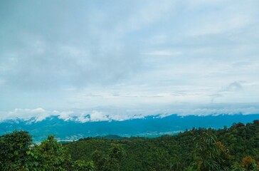 A mountain range with a cloudy sky in the background