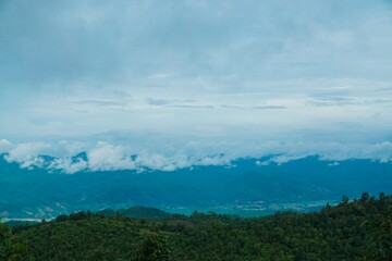 The sky is cloudy and the mountains are in the background